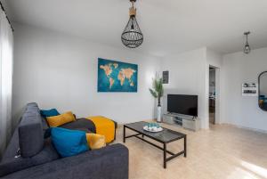 a living room with a couch and a tv at Mayas House Greece Rhodes Kremasti in Kremasti