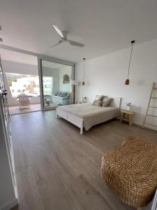 a white bedroom with a bed and a large window at Cap Sa Sal suites -Apartament Begur - Costa Brava in Begur