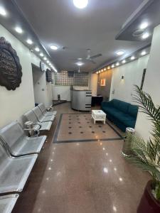 a waiting room with a couch and chairs in a room at Grand Hotel Qena in Qinā
