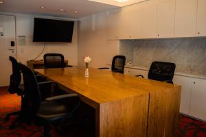a conference room with a large wooden table and chairs at Pleno Palermo Soho in Buenos Aires