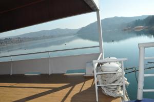 a white chair sitting on the deck of a boat at Hotel Brod Panini Veles in Veles