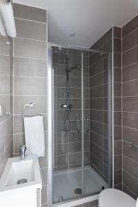 a bathroom with a shower and a toilet and a sink at Appart Hotel Corte HR in Corte