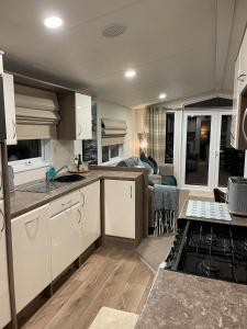 a kitchen and living room of an rv at Ravenwood Lodge in Dollar