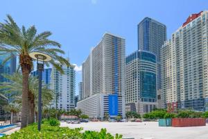 a city skyline with tall buildings and a palm tree at Centric Modern 40thFloor Brickell Condo FREE parking by Palermo Home Miami in Miami