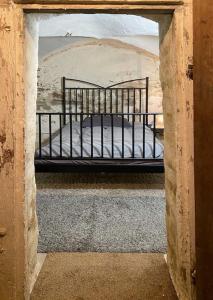 a bedroom with a bed in an open doorway at Denkmalgeschützter Bauernhof in Schauenstein