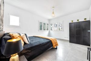 a bedroom with a bed and a black cabinet at Sweet garden Las palmas in Las Palmas de Gran Canaria