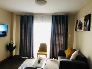 a living room with a couch and a window at Menlyn Bizcation Accommodation in Pretoria