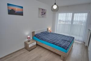 Posteľ alebo postele v izbe v ubytovaní Apartament Słoneczny 11