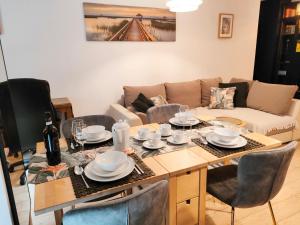 a living room with a table and a couch at Apartament dla 1-4 osób w Golden House in Wrocław