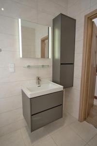 a bathroom with a sink and a mirror at Apartament Słoneczny 11 in Opole