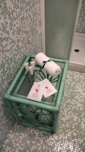 a green table with towels on it in a bathroom at SeaSide in Giardini Naxos