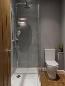 a shower in a bathroom with a toilet at Cosy 2 Bedroom Apartment in Todmorden