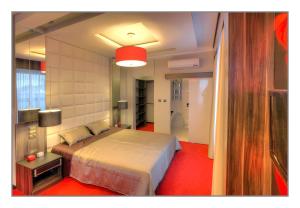 a bedroom with a bed and a red carpet at Villa Park in Siedlce
