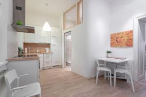 a kitchen with a table and a table and chairs at Danube Art Apartments in Vienna