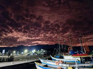 a group of boats docked in a marina at night at Suítes da Val in Paraty