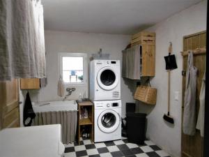 a laundry room with a washer and dryer on the wall at Le petit mas en provence avec piscine in Barbentane