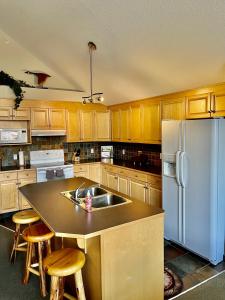 een keuken met houten kasten en een witte koelkast bij Canmore Crossing in Canmore