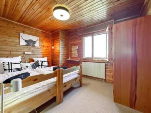 a bedroom with two beds in a wooden cabin at Mirador Lodge - Crans Montana - Swiss Alps in Crans-Montana