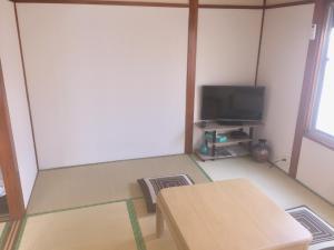 an empty room with two tables and a tv at D-pdal Inn - Vacation STAY 39054v in Tokyo