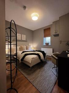 a bedroom with a bed and a room with a spiral at Modern Ground Floor Apartment in Todmorden