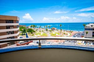 a balcony with a view of the beach and the ocean at Hotel Piramide Pituba - Rua Pernambuco in Salvador