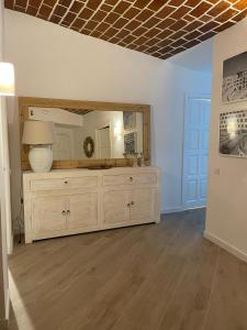 a room with a dresser and a mirror on the wall at Cap Sa Sal suites -Apartament Begur - Costa Brava in Begur