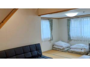 - un salon avec un canapé et un lit dans l'établissement Sudomari no Yado Sunmore - Vacation STAY 46748v, à Nikkō