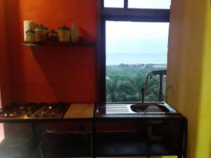cocina con fogones horno superior junto a una ventana en Maremonti Vacation Rental, en Puerto López