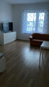 ein leeres Wohnzimmer mit einem Sofa und einem TV in der Unterkunft Zentral gelegene Apartments in Gelsenkirchen für bis zu 5 Personen in Gelsenkirchen