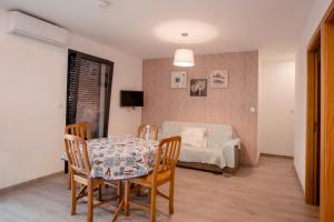 a dining room with a table and chairs and a couch at FOZDOVEZ in Souto