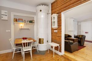 a kitchen and dining room with a table and chairs at HagbackensGård Bed&Breakfast in Örebro