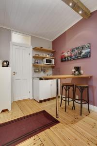 a kitchen with a table and chairs in a room at HagbackensGård Bed&Breakfast in Örebro