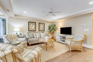 a living room with a couch and a tv at Tennis Club 4709 in Kiawah Island