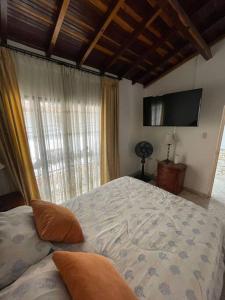 a bedroom with a large bed and a large window at Apto. en zona céntrica con vista panorámica al pueblo in San Gil
