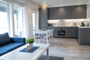 a kitchen and living room with a couch and a table at Skaimsberg Holiday Apartments in Aurland