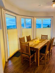 a dining room with a wooden table and chairs at Sonnenberg Resort in Elzach