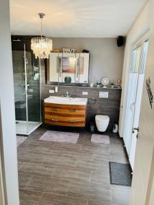 a bathroom with a sink and a shower at Sonnenberg Resort in Elzach