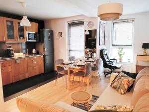 a living room and kitchen with a table and a couch at Apartament dla 1-4 osób w Golden House in Wrocław