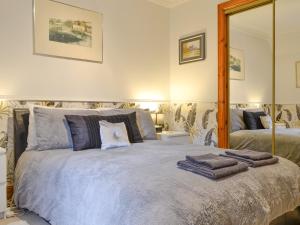 a bedroom with a large bed with towels on it at Dee Valley View in Aboyne