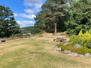 a picnic table in the middle of a field at Dee Valley View in Aboyne