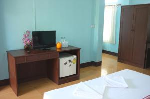 a living room with a tv on a table at Zam Zam House in Ko Lanta