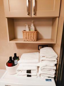 a pile of towels on a shelf in a bathroom at Apartament dla 1-4 osób w Golden House in Wrocław