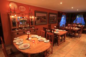 a dining room with a wooden table and chairs at Avalon Guest Manor in Newcastle