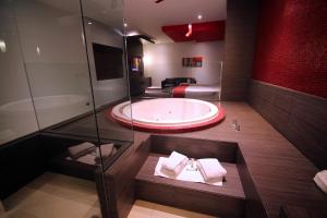 a bathroom with a large tub in a room at Motel Via in Tijuana