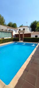 a large blue swimming pool in front of a building at Vivienda Turística Rural in Granada