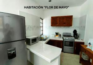 a kitchen with a refrigerator freezer and a microwave at Departamentos Ileana in Cozumel