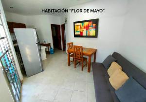 a living room with a couch and a table at Departamentos Ileana in Cozumel +7 photos