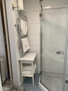 a bathroom with a shower with a table and a sink at California guest house in Greenwich