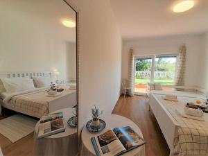 a bedroom with a mirror and a bed and a living room at Romantic Apartment Anna in the center of Krk in Krk