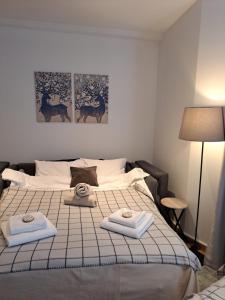 a bedroom with a bed with two towels on it at Falling Star Apartman Brzece in Brzeće